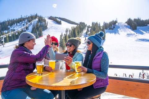 Group of four enjoying drinks outdoors
