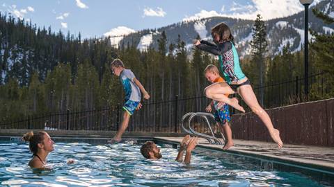 kids jumping into swimming pool
