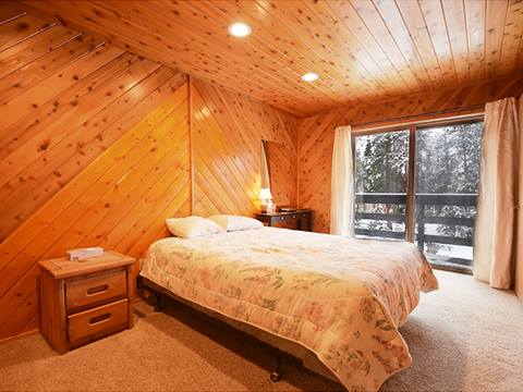 A bedroom at the 61 Jabberwocky vacation rental at Winter Park Resort
