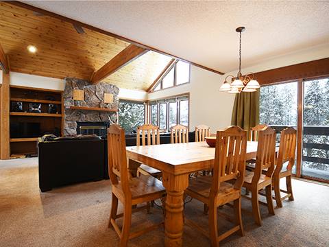 Dining Area with wooden ceiling and wooden table. 