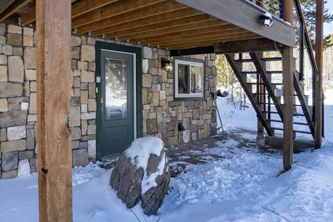 View from exterior of house with stairs leading down to the basement. 