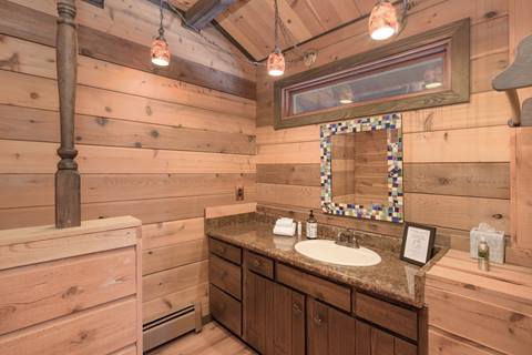 1/2 bathroom with wooden walls. 