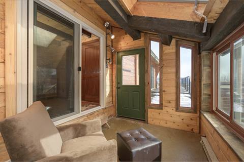 Seating area with chair in sunroom. 