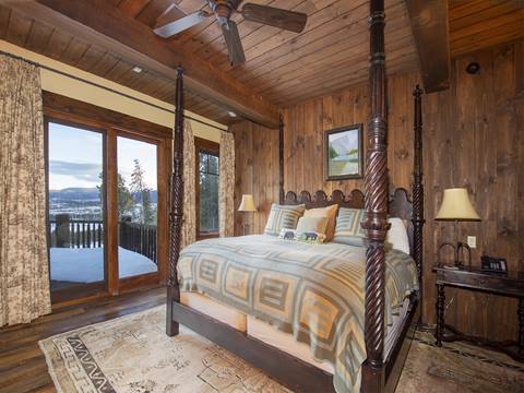 Lavish bedroom with four post bed and colorful dressings. 