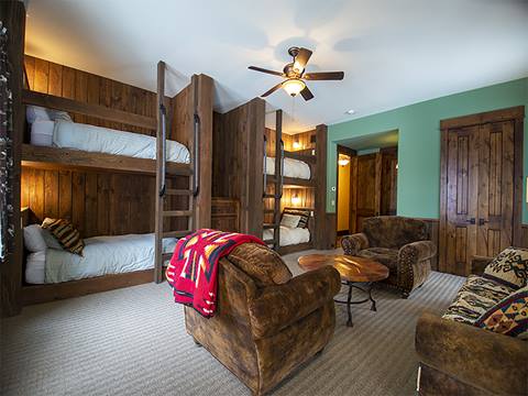 Bunk bedroom with recliner in the middle. 