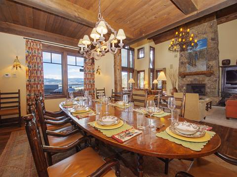 Wooden dining room table with warm lighting. 
