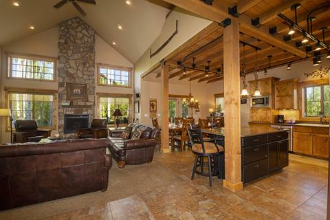 Main living room area with vaulted ceilings and wood beams. 