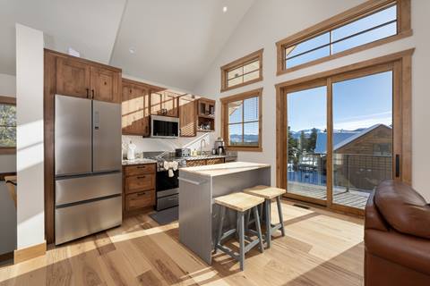 Kitchen close-up with granite counters, stainless appliances, and wooden cabinetry.