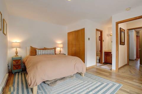 Bedroom with queen bed, nightstands, and direct access to bathroom through adjoining door.