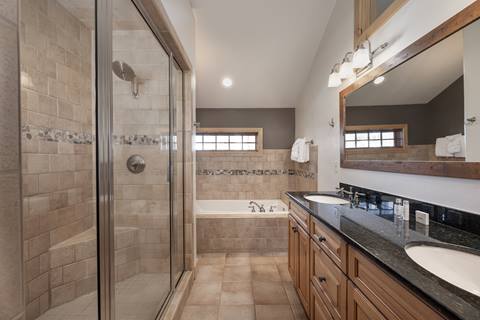 Spacious master bathroom with dual sinks, walk-in shower, and soaking tub.