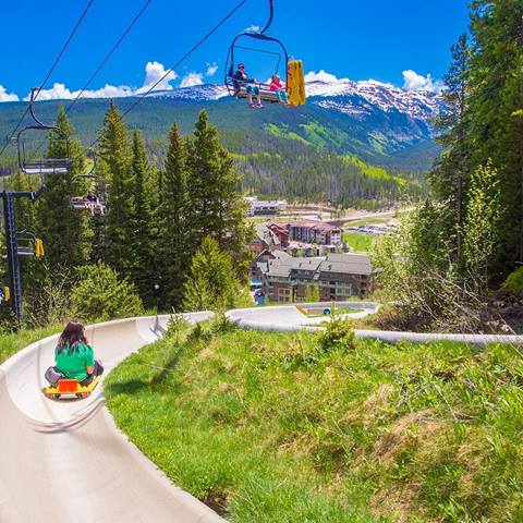 person riding the alpine slide included with the unlimited activity summer day pass at winter park resort, colorado