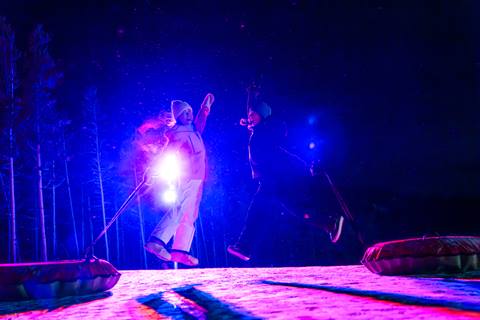 snow tubers high fiving at night snow tubing at winter park resort