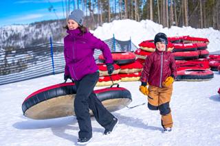 Woman and child tubing at Winter Park Resort