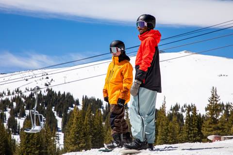 Two snowboarders at the top of Winter Park Resort