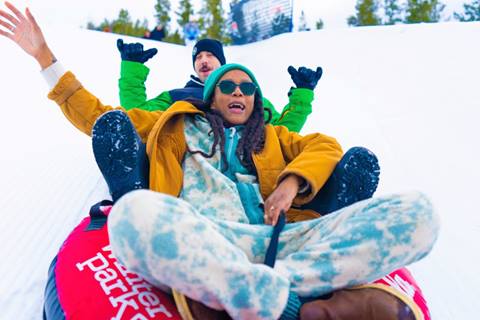 Adult couple tubing at Winter Park Resort