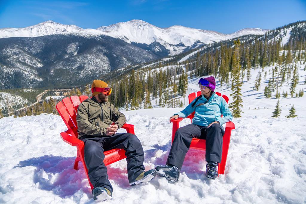 Two people in chairs on snow at Winter Park Resort