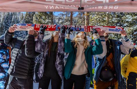 Group taking a shot out of a ski at Winter Park Mary Jane Party
