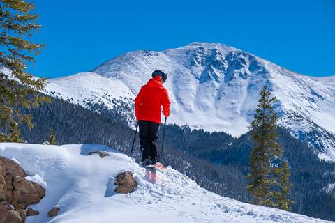 Skier rides fresh corduroy at winter park resort