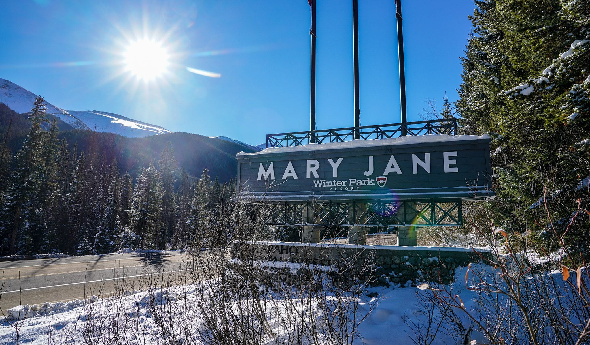 Entrance of Mary Jane with sun shinning behind the sign. 