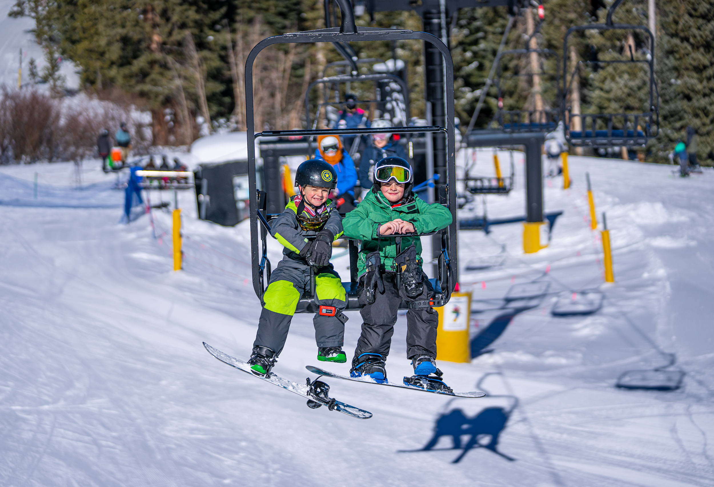 2 kids on a chairlift during a lesson