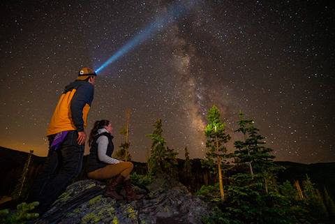Two people stargaze at winter park.