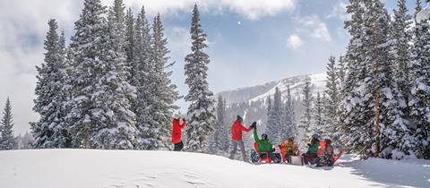 a group of friends enjoy a snowy winter park resort