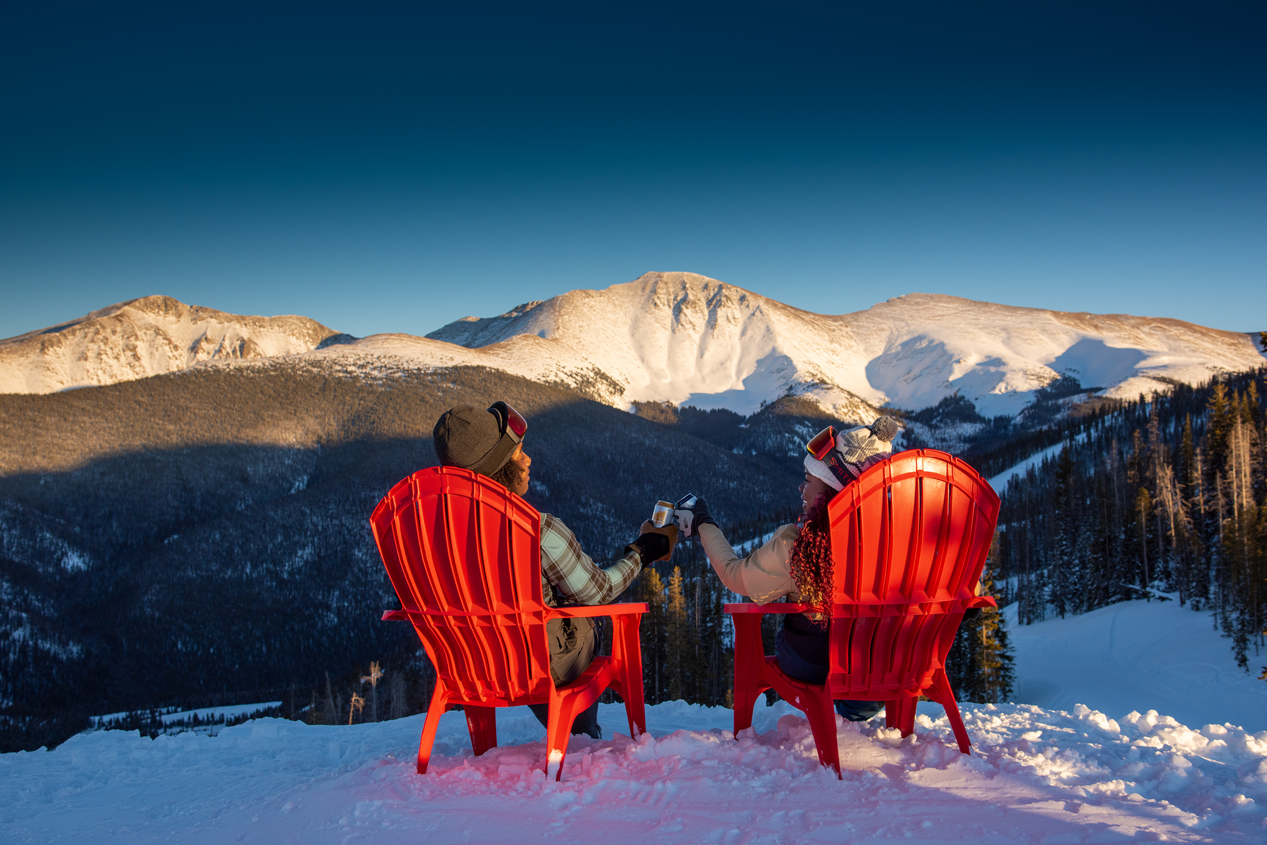 Couple enjoying a beverage and the view of Perry Peak
