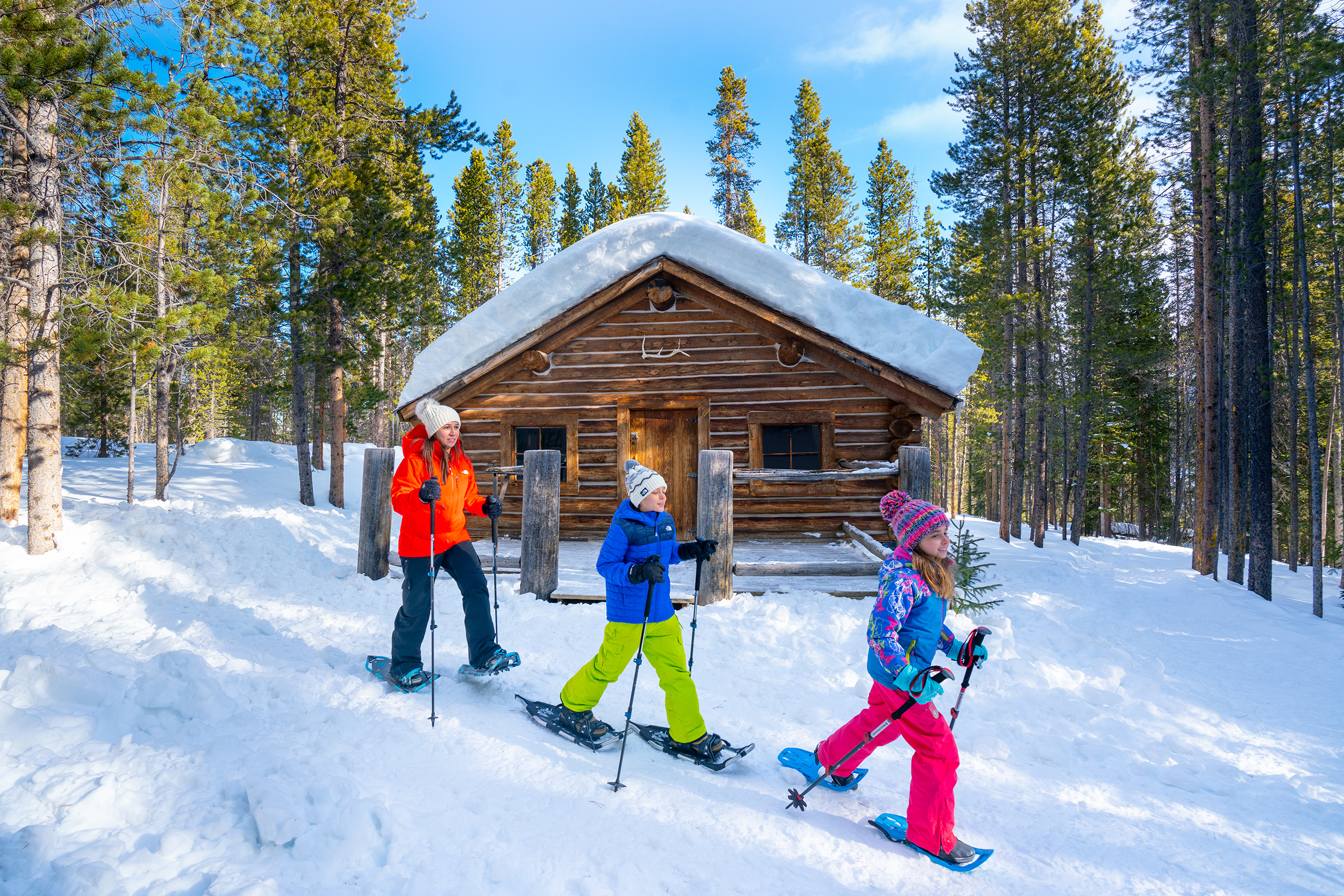 Family snowshoes past willies cabin at winter park resort